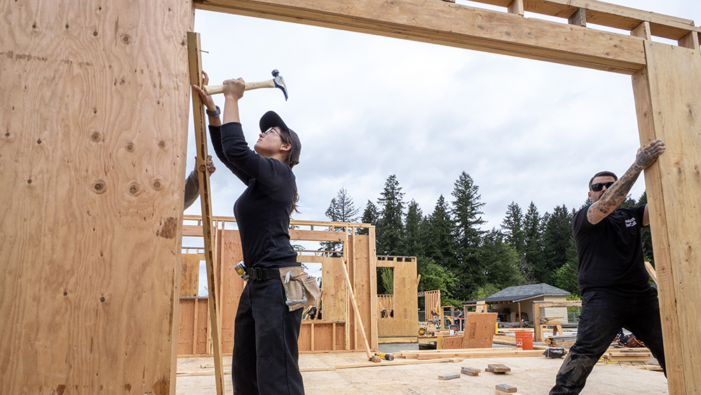 Students framing a wall