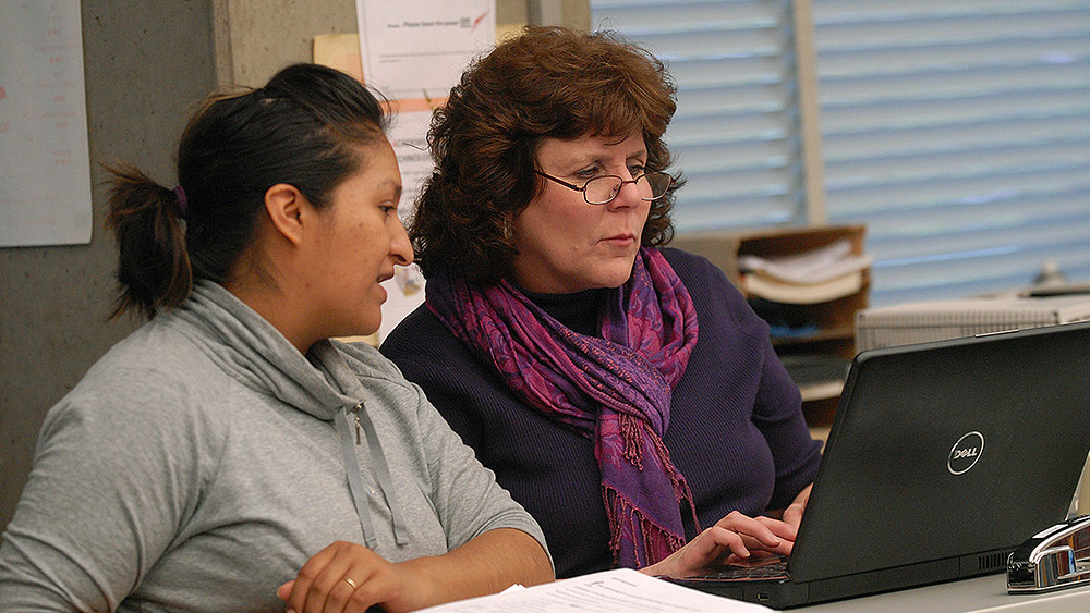 Students working on a laptop in class