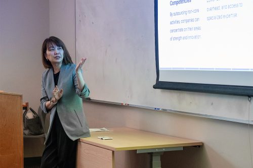 Business instructor giving a presentation in front of class