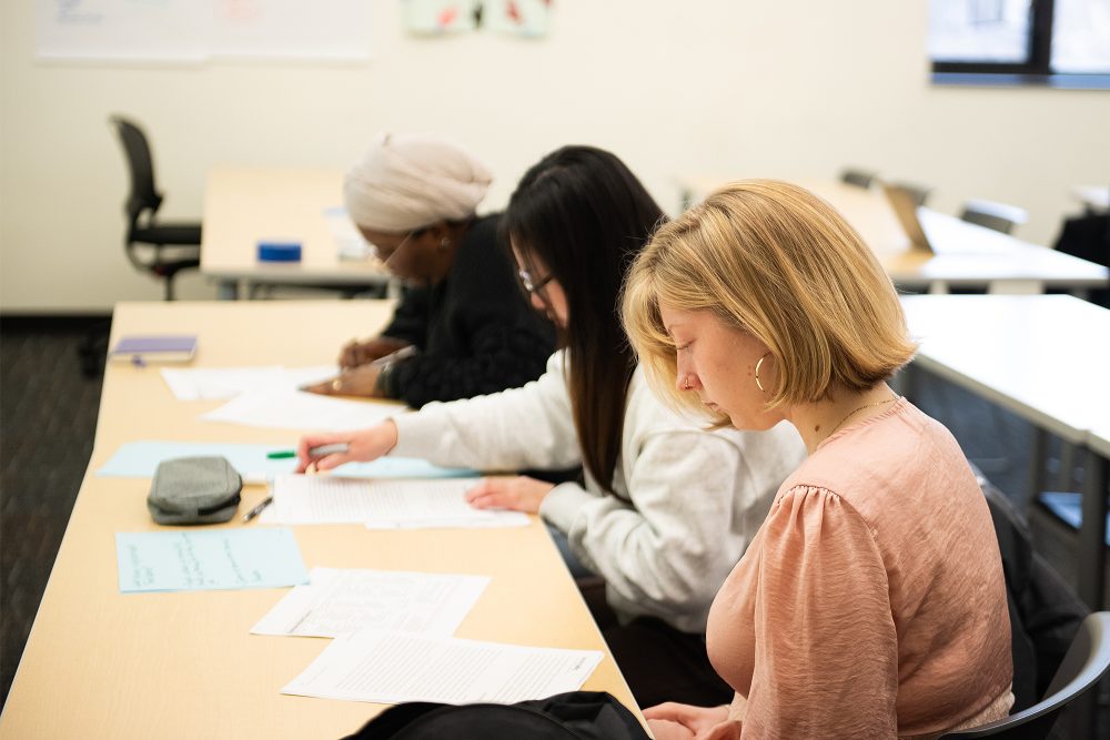 Students working on worksheets in a business class