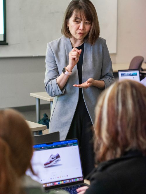 Instructor using her hands to demonstrate a concept in class