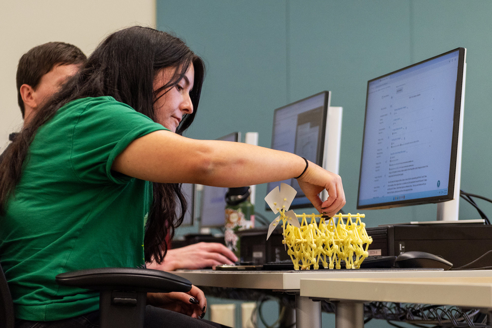CADD student in class looking at a kinematics machine