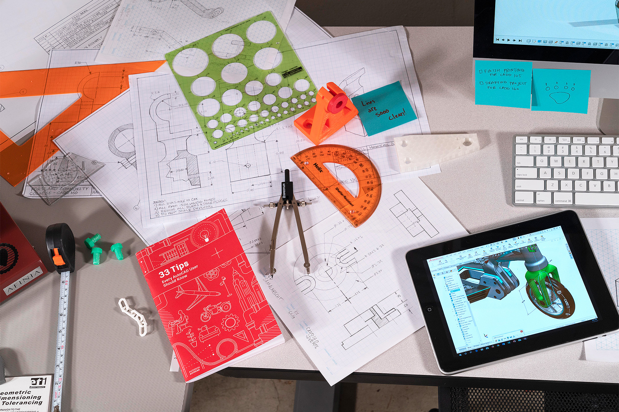 CADD tools and drawings spread across a workstation