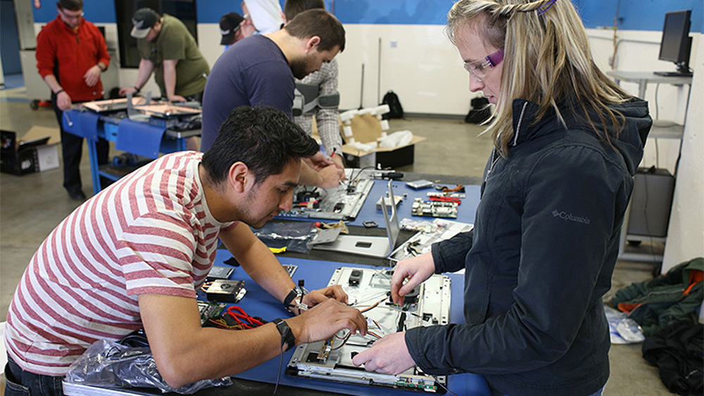 Students working on computer hardware together