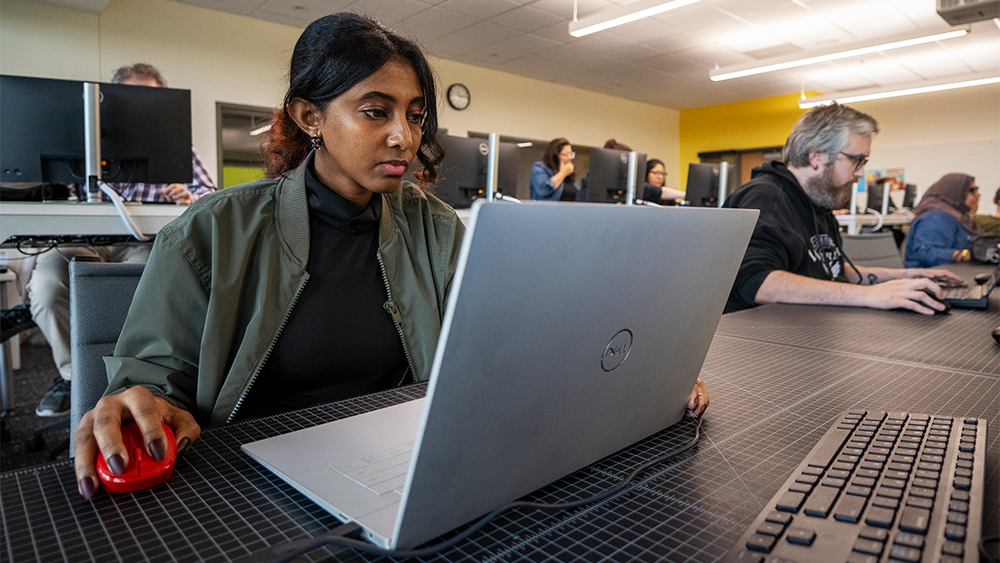 Student working at a computer in class