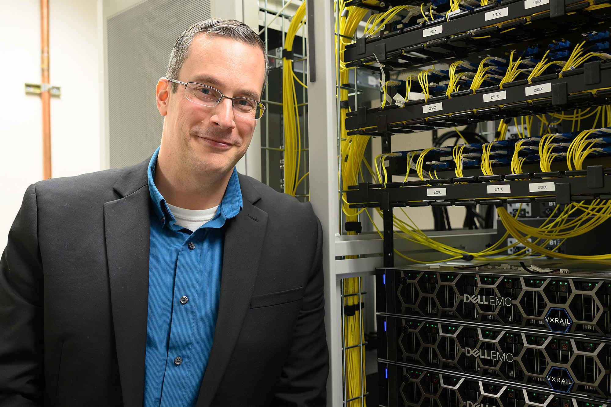 CIS instructor standing next to a server