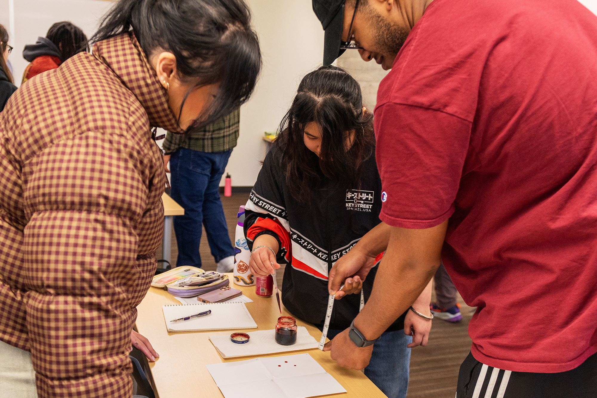 Criminal Justice students measuring in the forensics lab