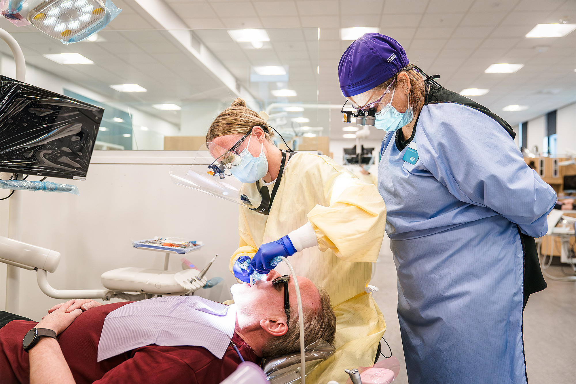 Dental Hygiene students working with a mock patient