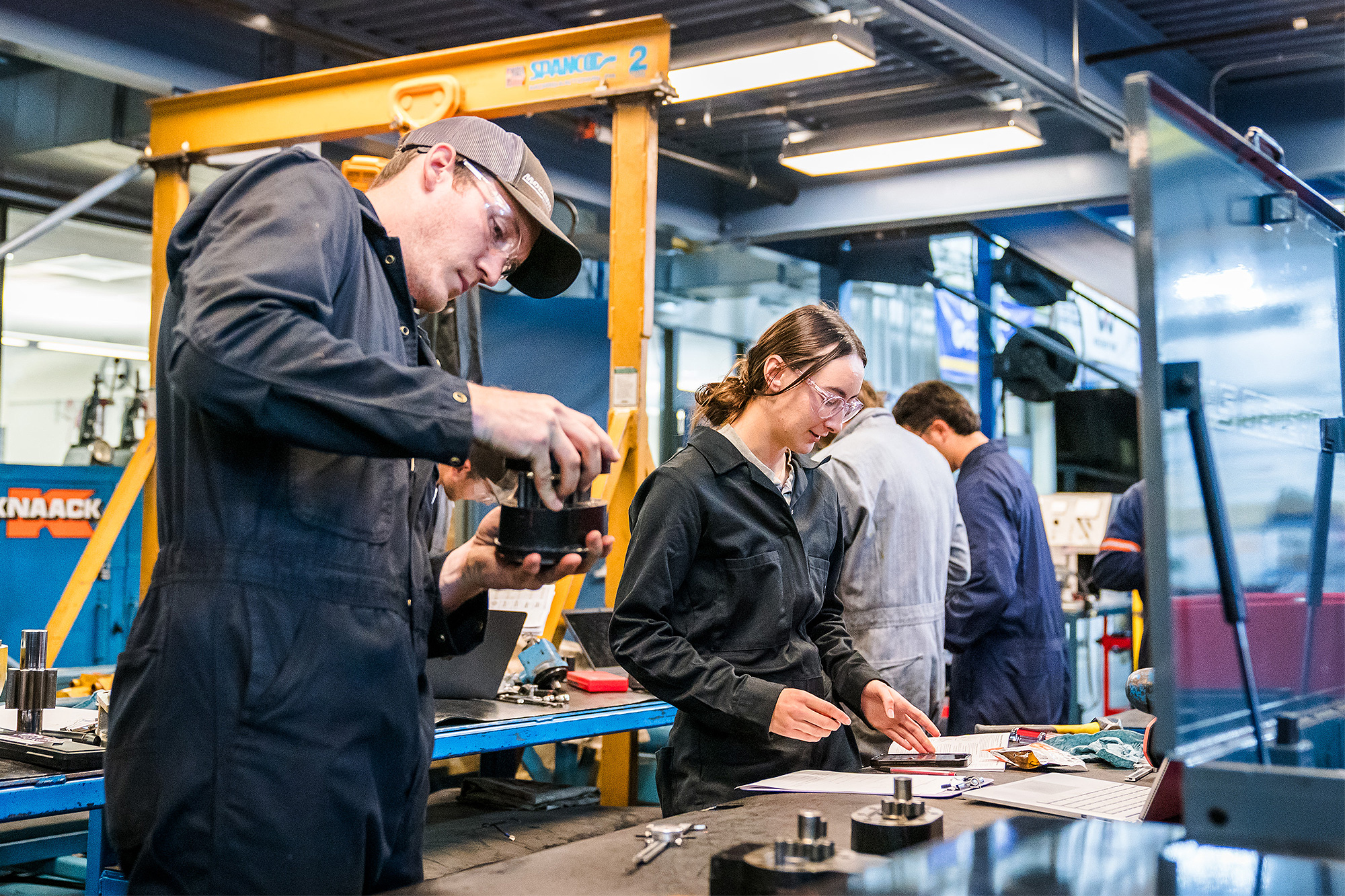 Diesel Service students working on a table of parts in the shop