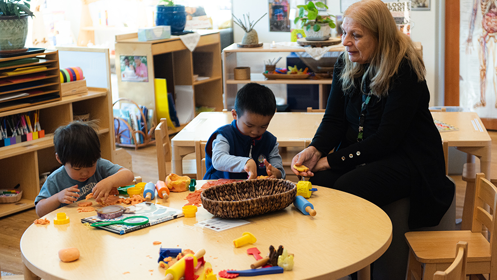 Preschool children in a classroom with their teacher