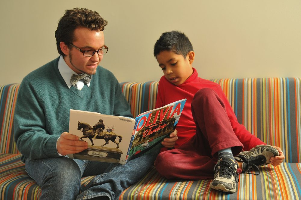 Teacher reading to a student