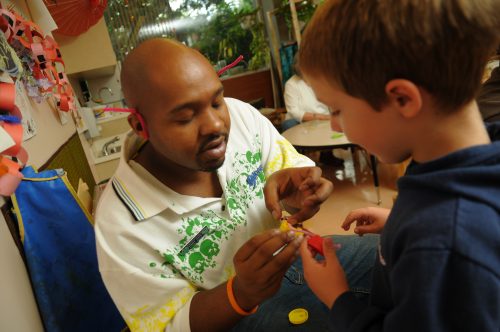 Teacher helping a young student