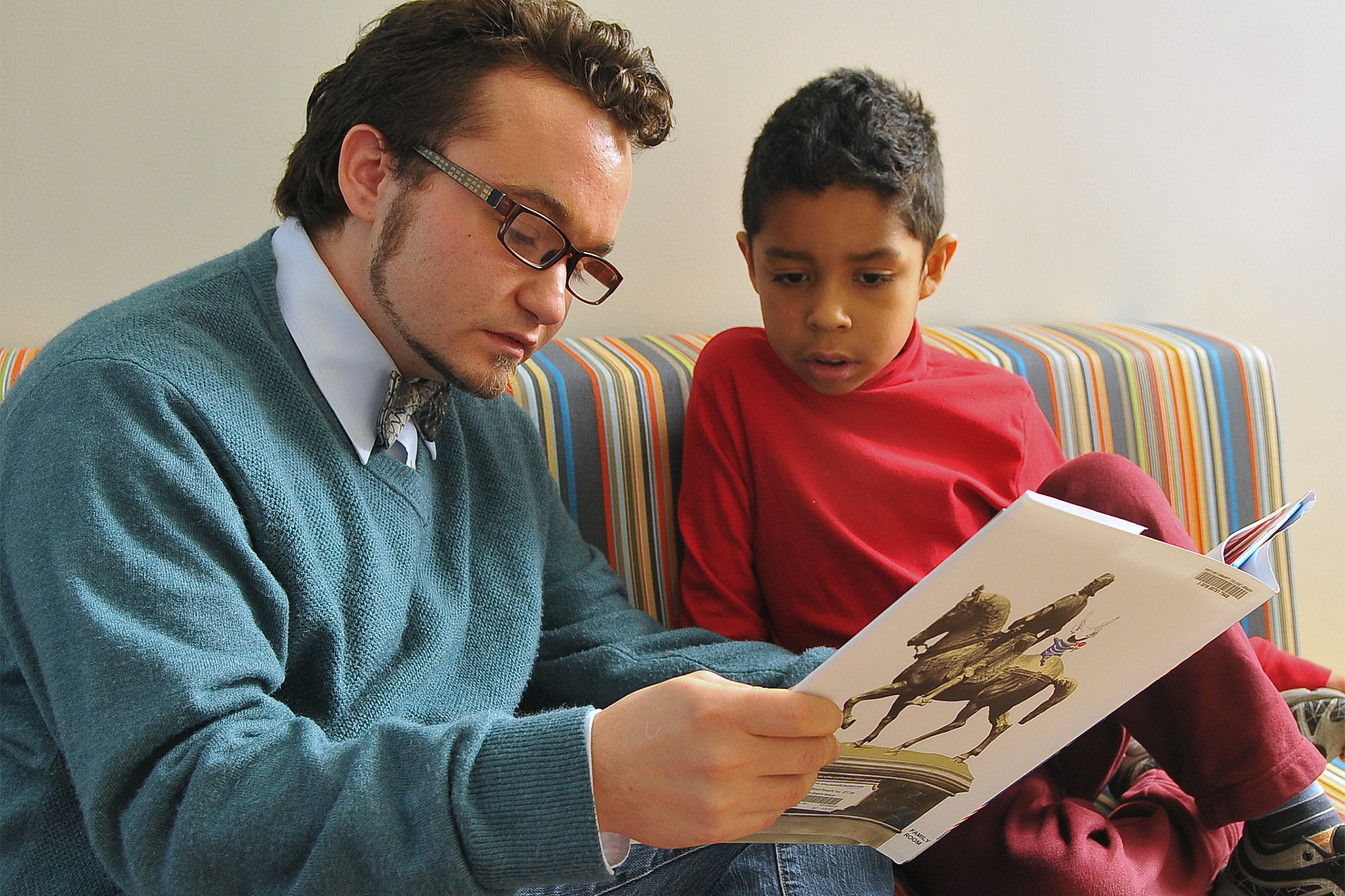 Teacher reading to a young student