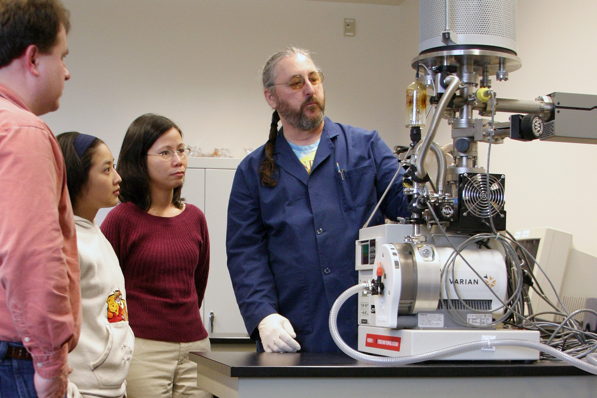 Electronic Engineering Technology instructor showing a medical device to students in class