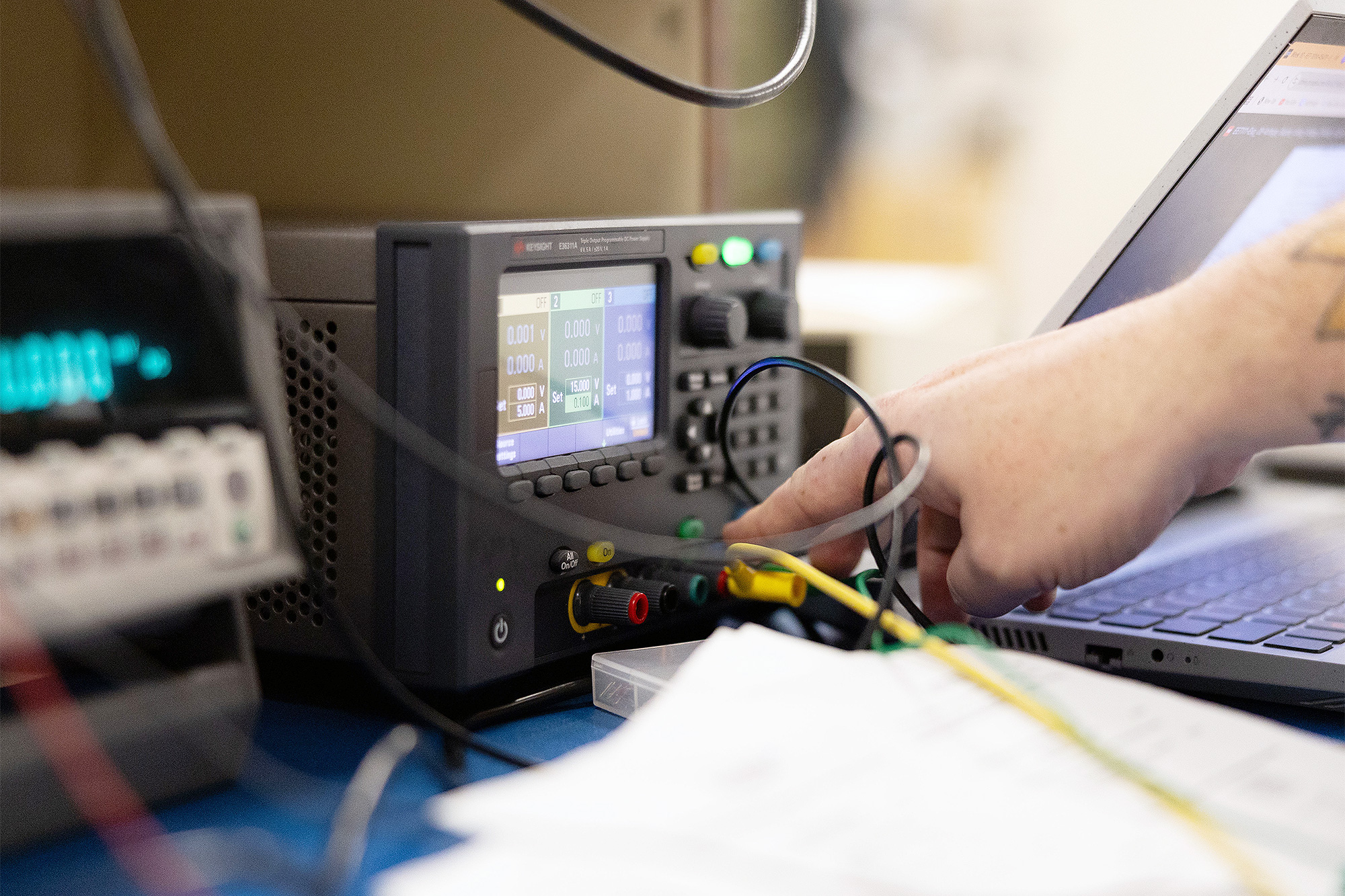 Electronic Engineering Technology student working with a voltage monitor