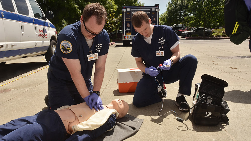 Students giving CPR to a dummy in a simulation