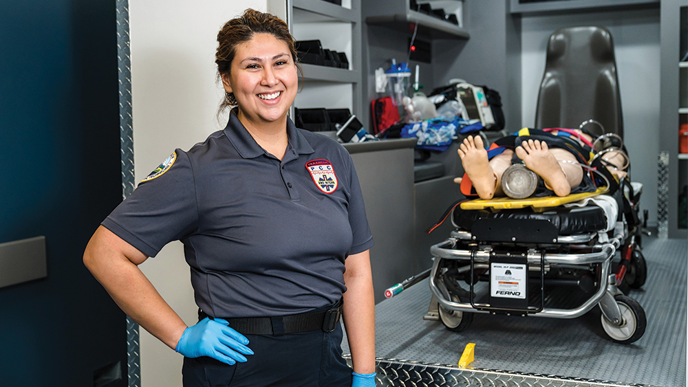 Fire/Paramedic student in front of the simulator ambulance