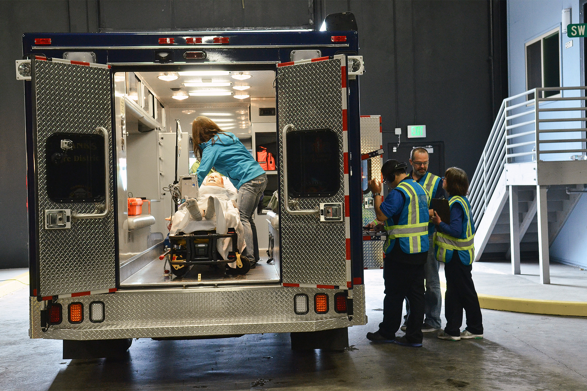 EMS students with a dummy patient on a mock street corner