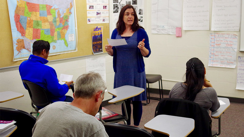 Instructor talking to class in front of map