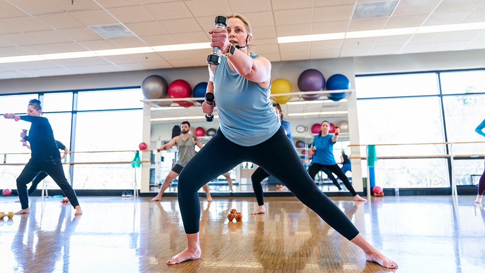Student exercising in barre class