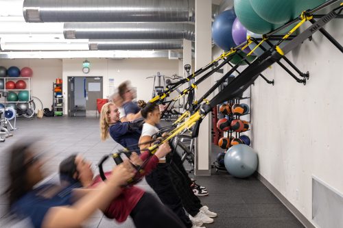 Students working hard in a TRX class