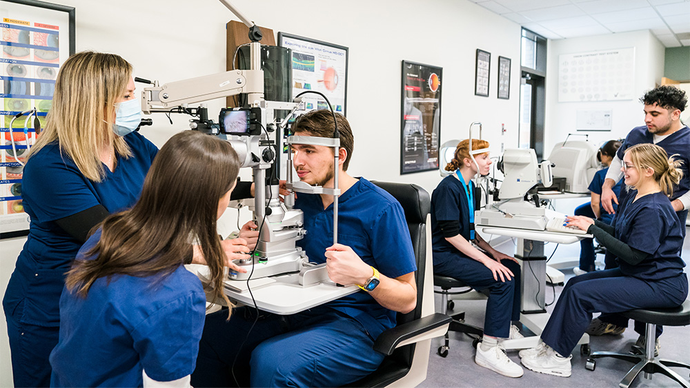 Eye Technician students using various tools in the lab