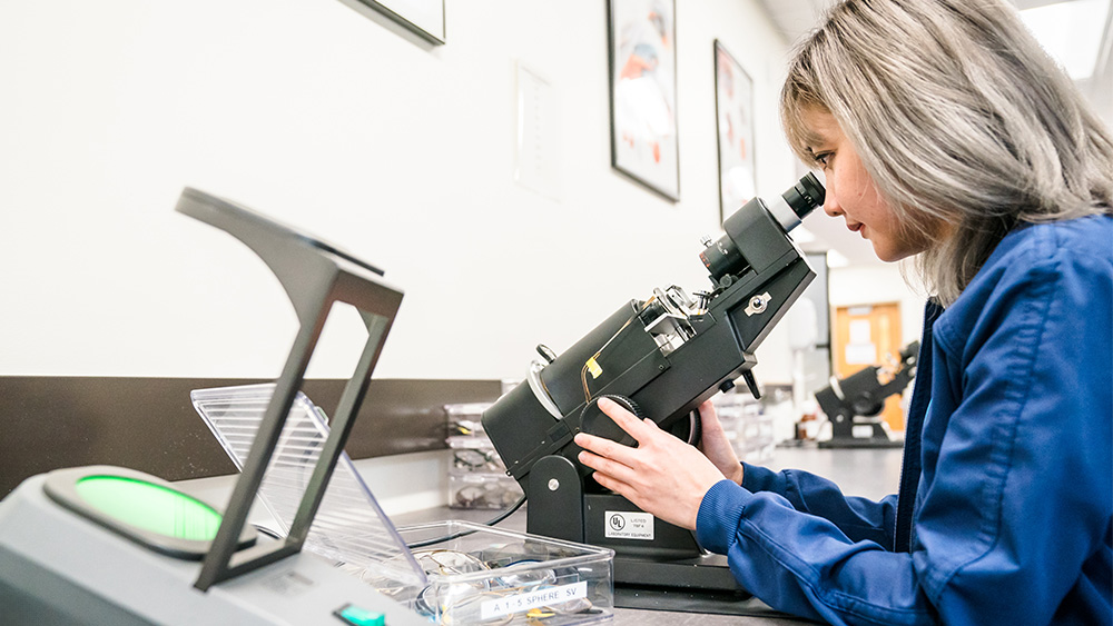 Student looking into a microscope