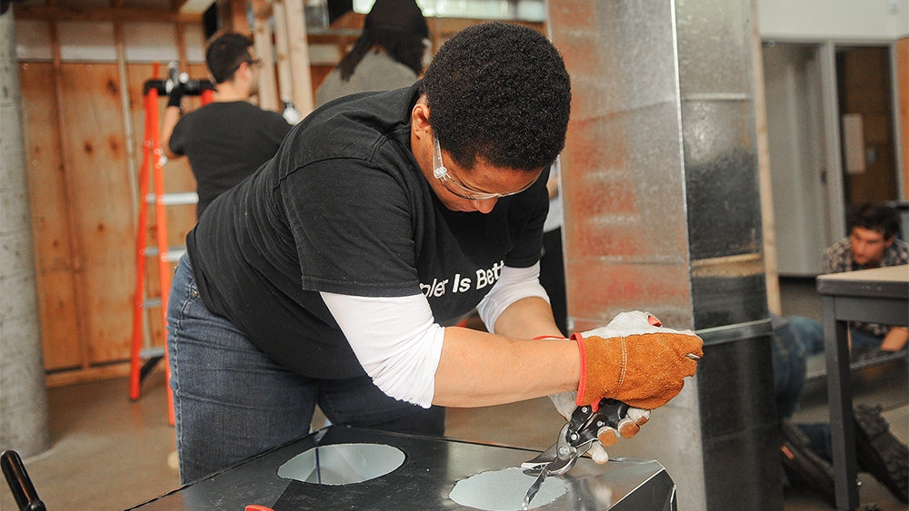 Student working with ducting