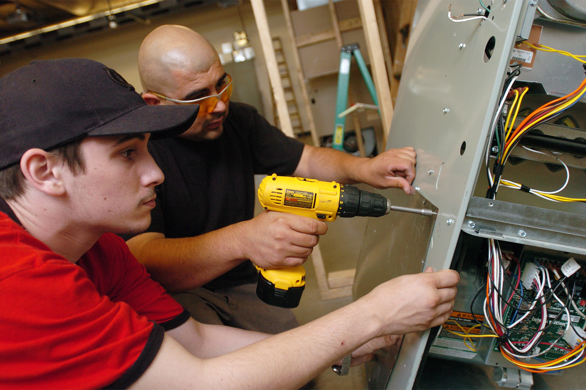 Facilities Maintenance students putting together an HVAC/R unit together