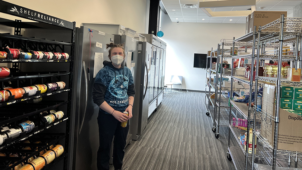 Student standing in a PCC food pantry