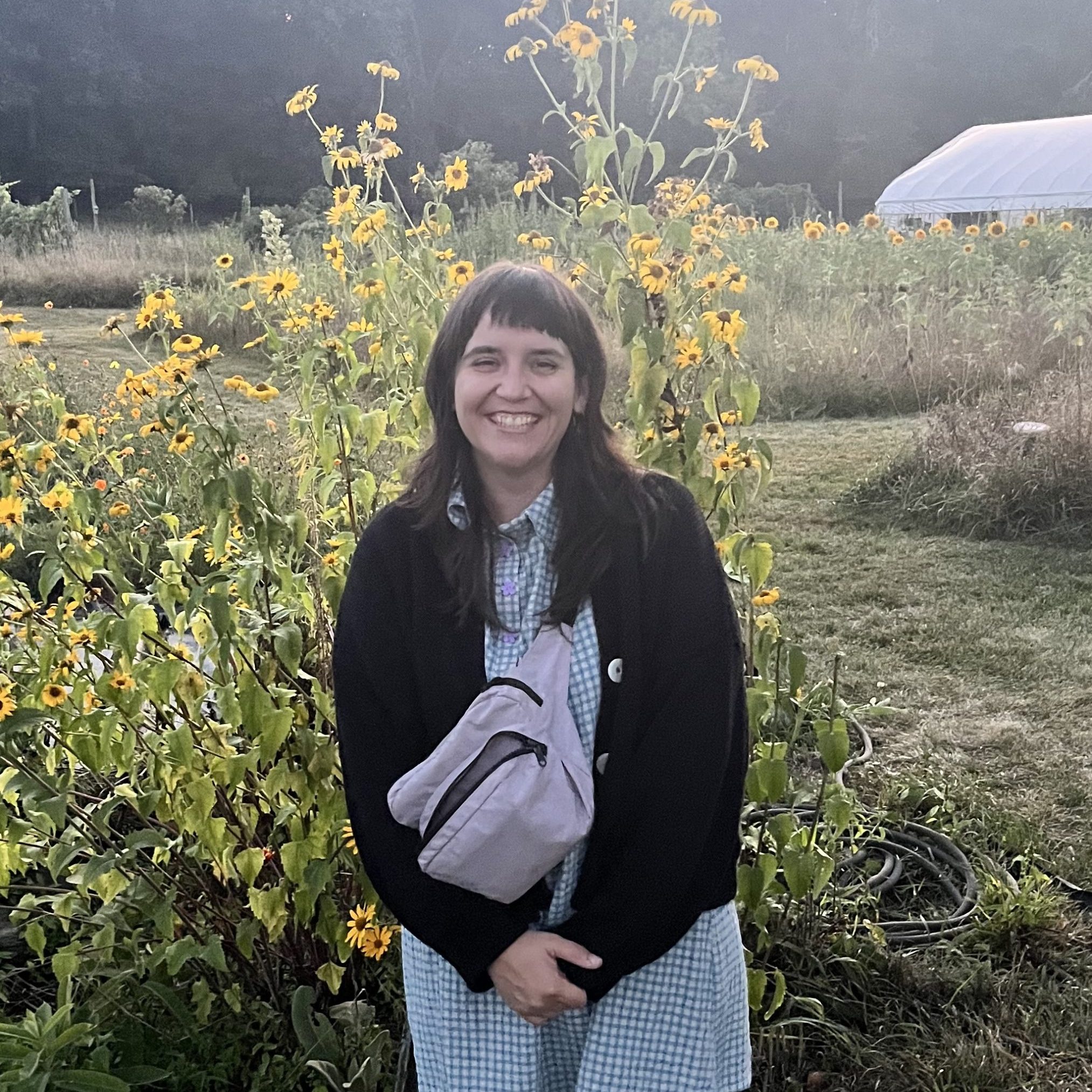 Shea standing in a field of flowers