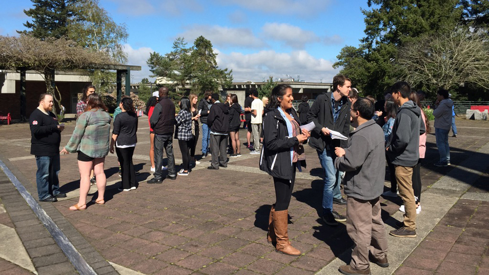 Class of students outside participating in speaking activity