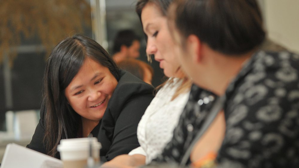 Three students working together in class