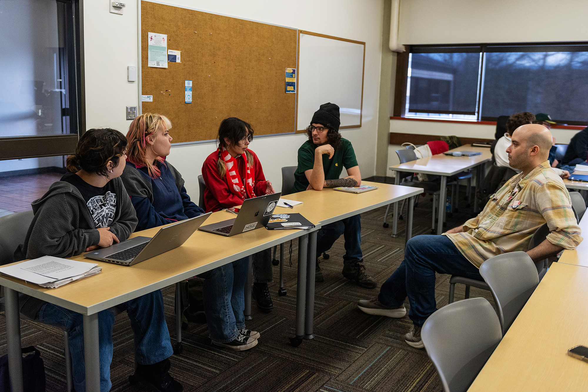 Creative Writing students having a discussion in class while the instructor listens