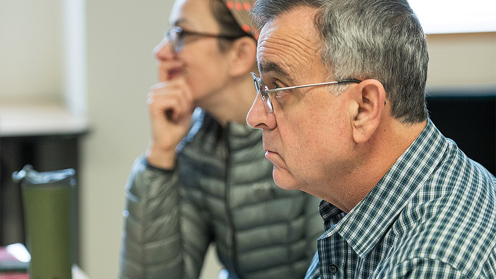 Older adults listening to an instructor