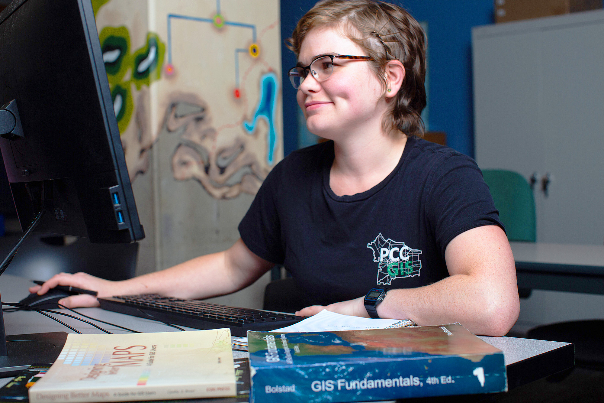 GIS student working at a computer