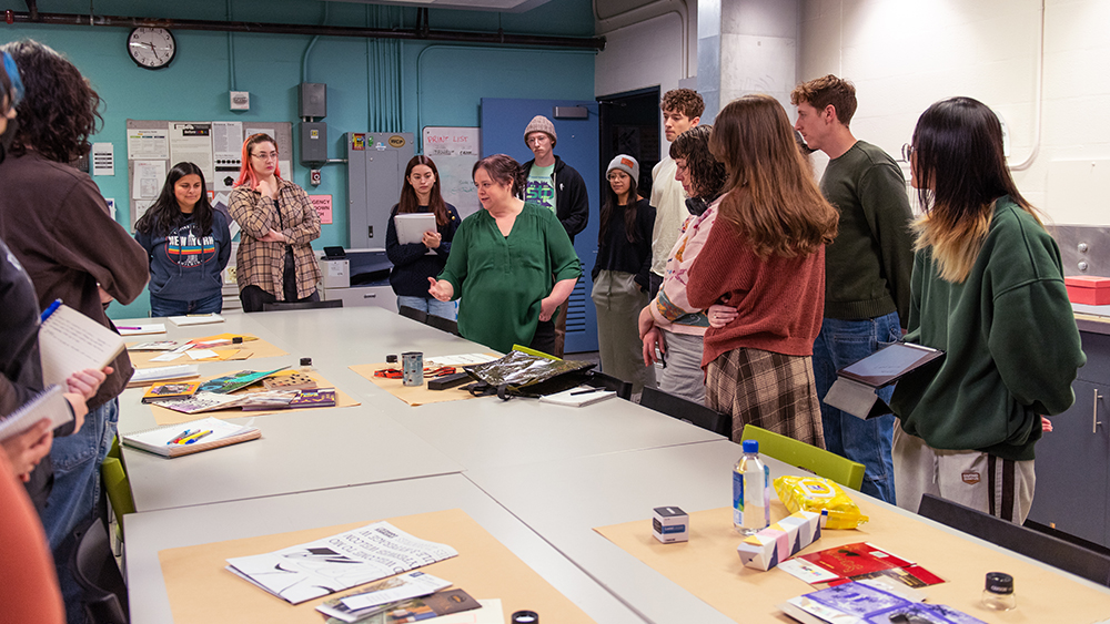 Teacher in front a graphic design class 