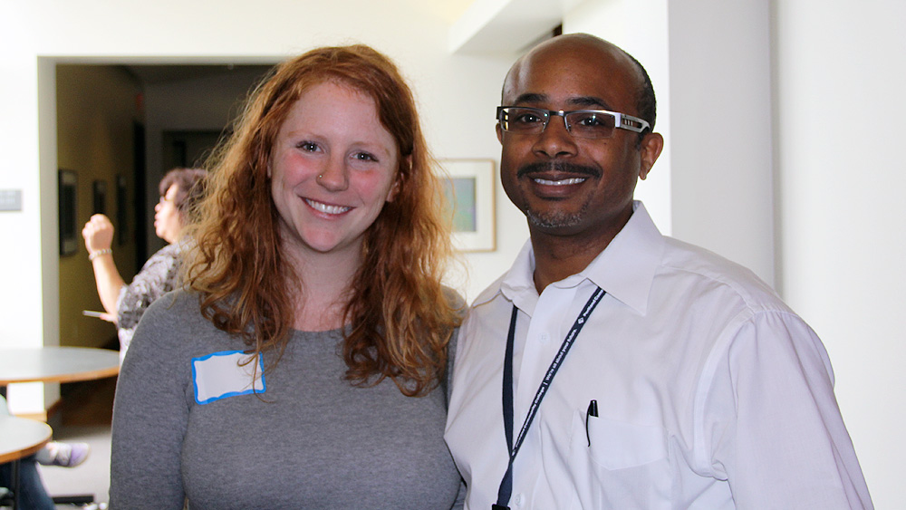 Student and teacher standing in a classroom together