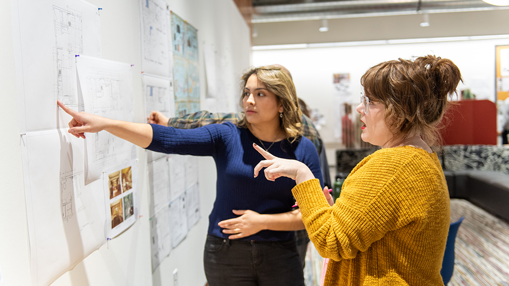 Pointing at some interior design plans