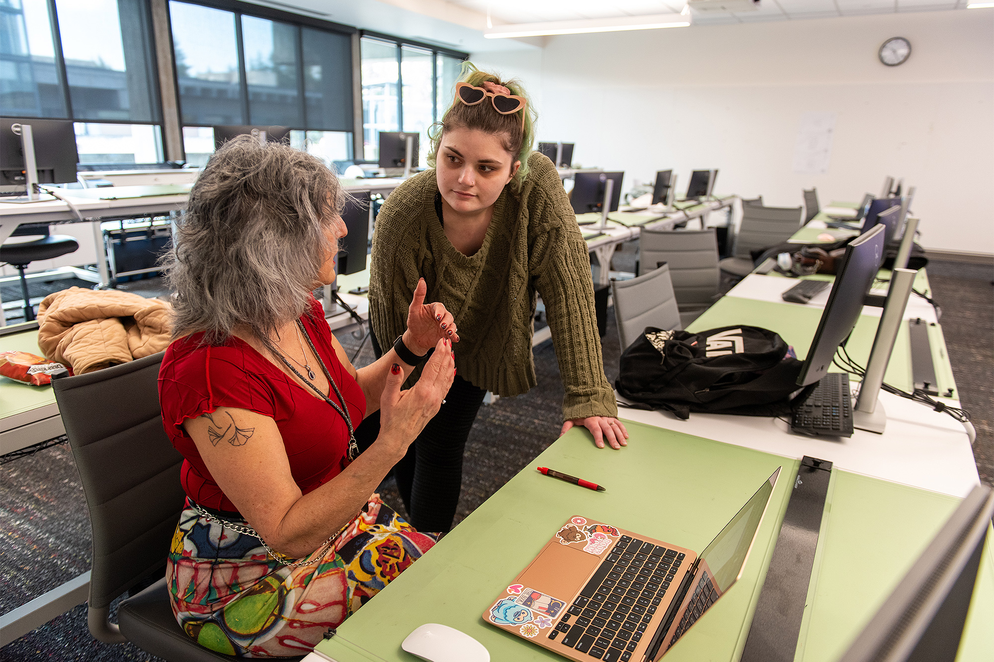 Interior Design instructor working with a student at a laptop