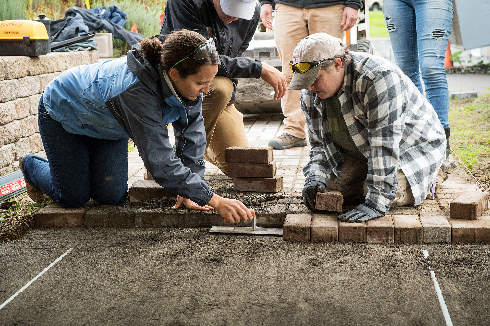 Landscape Tech students laying a brick walkway