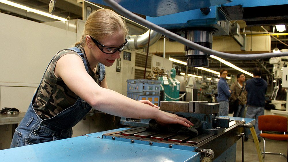 Student using machining equipment