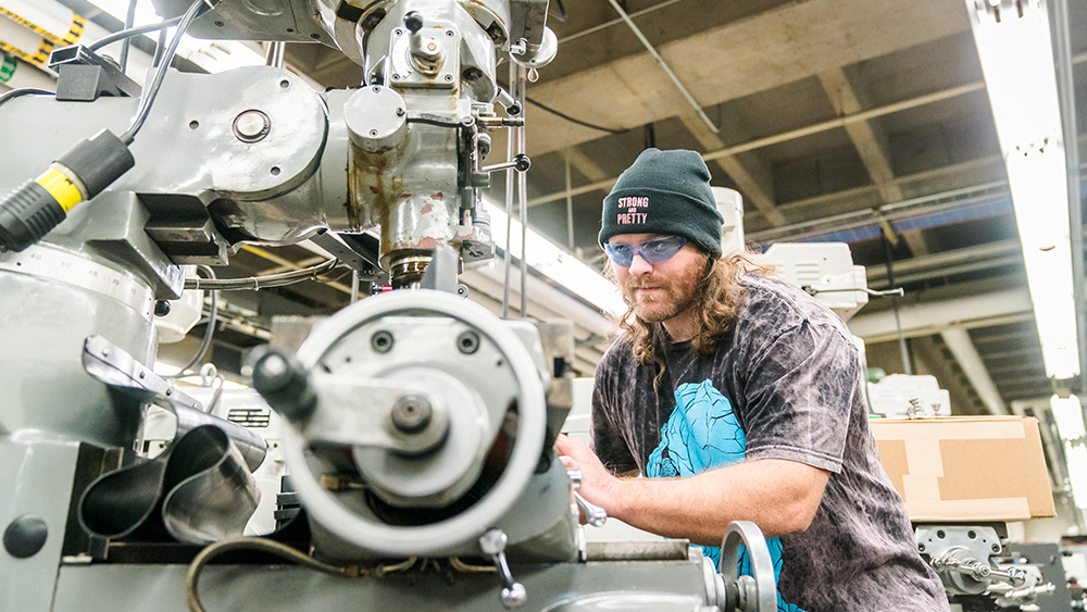 Student using machining equipment