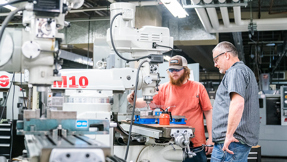 Student and instructor working in the machine manufacturing lab