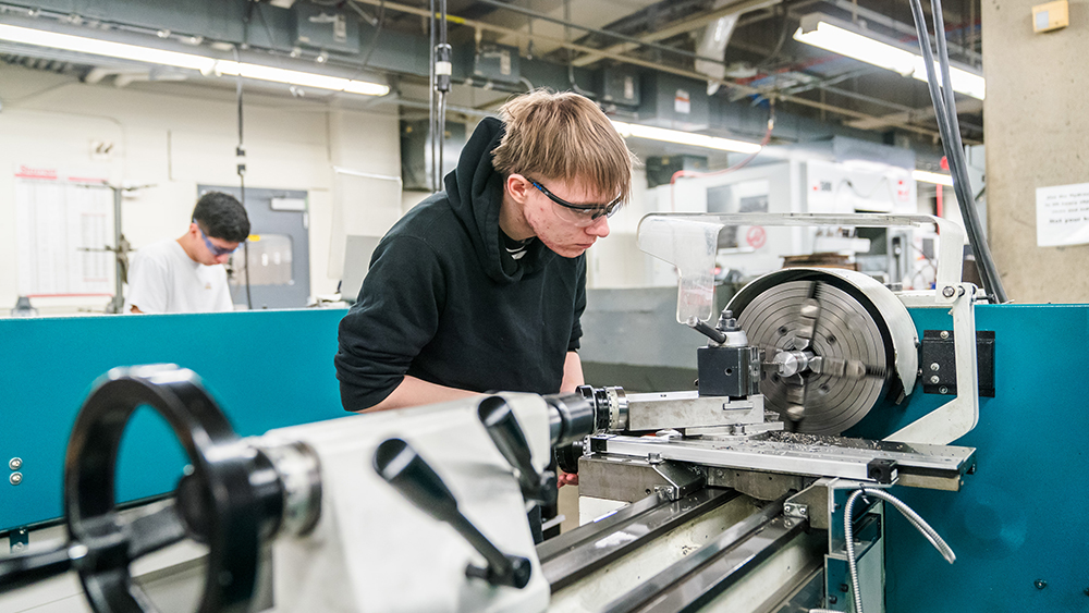Student using a CNC machine in the lab