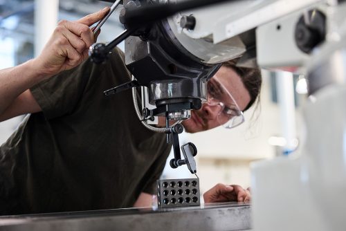 Student using a machine in the workshop