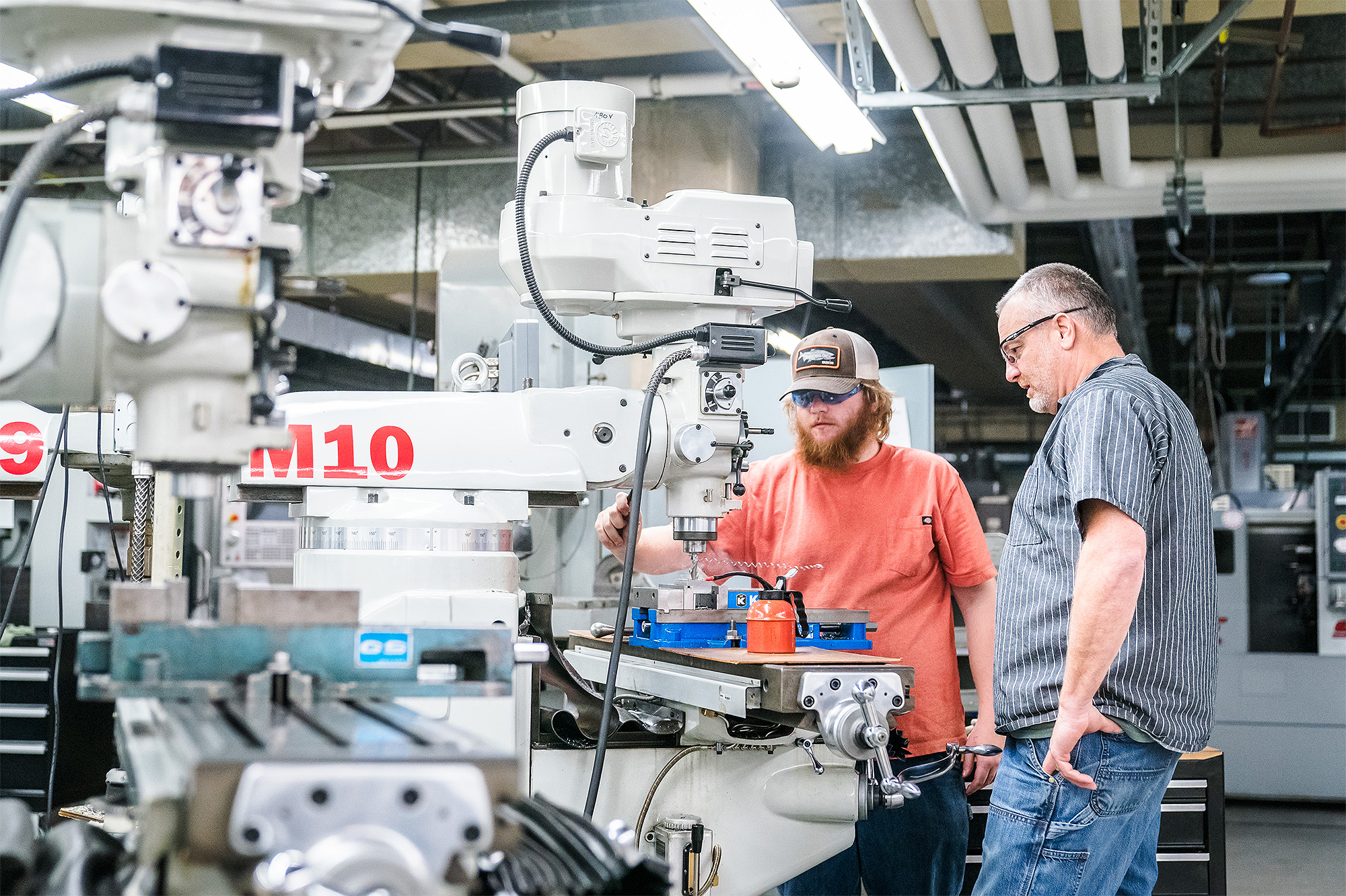 Machine Manufacturing student and instructor working in the lab