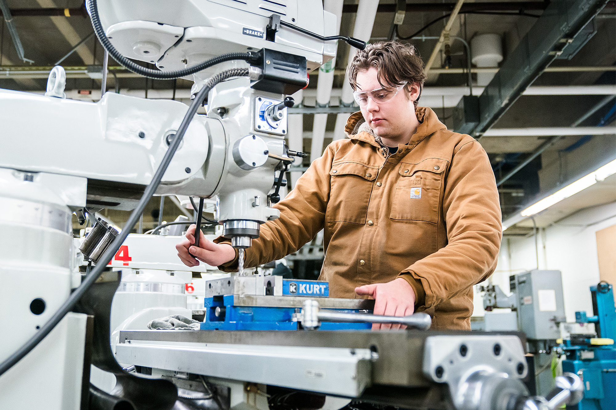 Machine Manufacturing student using a CNC milling machine