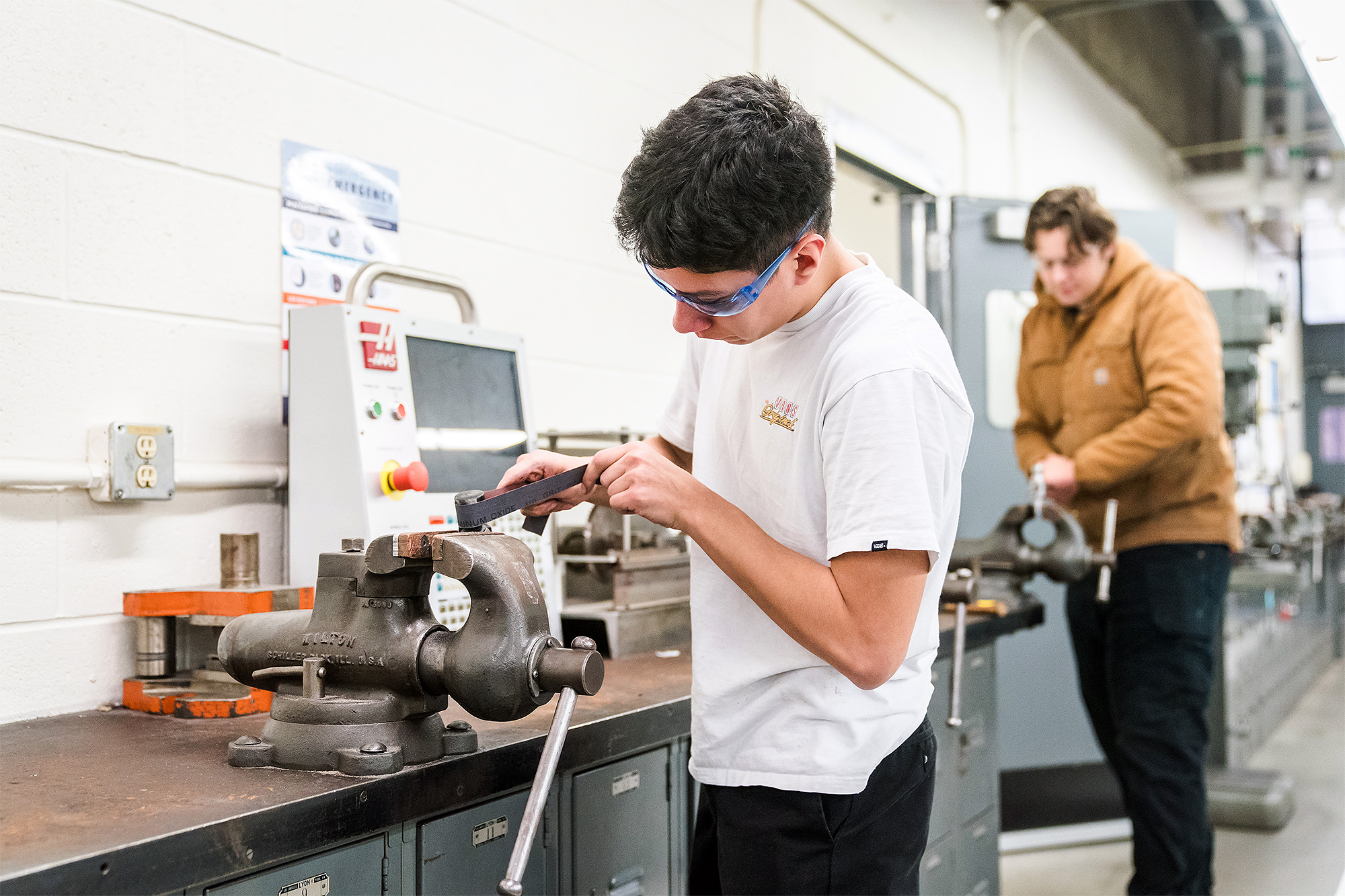 Machine Manufacturing students using hand tools in the machine manufacturing lab
