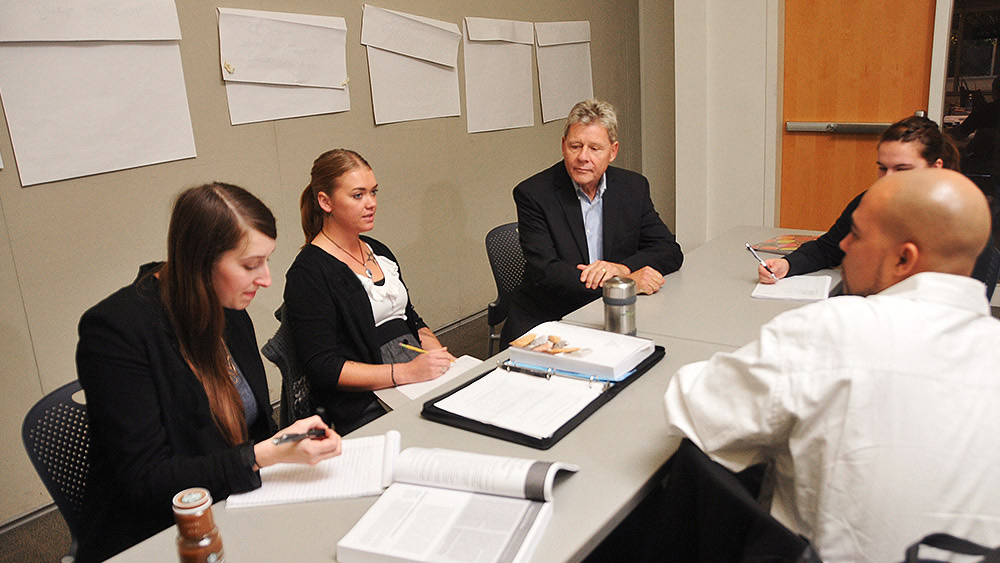 Students sitting around a conference table having a meeting